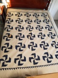 Handmade quilt blue and white pattern, has large stain