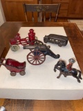 (5) Cast iron toys (cannon, Canadian Mountie, fire truck, bus).