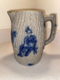 Stoneware pitcher w/ scene of man, 7 1/2