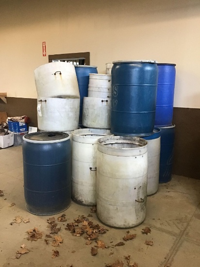 Large stack of plastic drums.