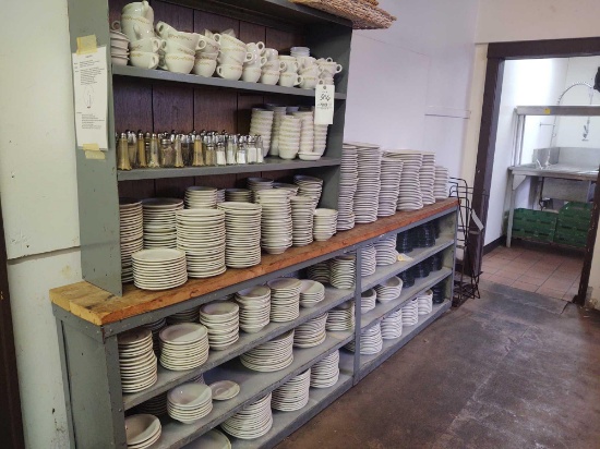 Assorted dishware including plates, bowls, cups, saucers, salt and pepper shakers, and baskets