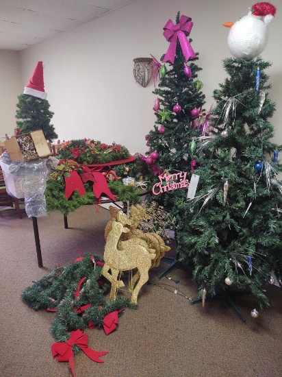 Assorted Christmas decor including two trees, wreaths and reindeers