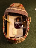 Basket Weaved Bassinet and Porcelain Doll