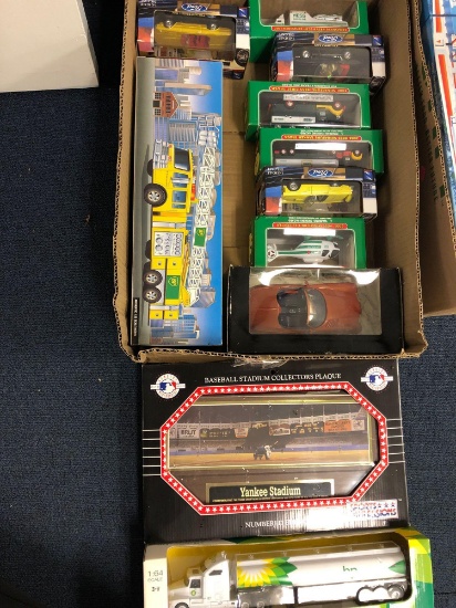 10 die cast vehicles in boxes and Yankees stadium collectors plaque