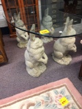 4 concrete rabbits and glass top table