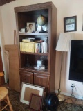 Bookcase with National Geographic DVDs, globe, lamp, picture frames and fan