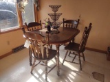 Dining room table with four chairs and fruit holder