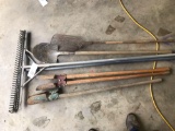 Two rakes shovel post hole diggers