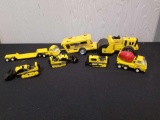 Box of yellow Tonka toys, mixer, dozers