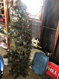 Milk can, wood stakes, flex water hose, Christmas tree