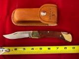 Schrade Uncle Henry folding knife w/ leather holder.
