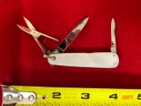 Remington #R7364 pocket knife w/ mother of pearl handle. Leather holder. No box.