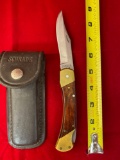 Schrade folding knife w/ leather sheath.