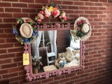 Wood Rose Bordered Mirror with Decorative Hats and Floral Arrangement