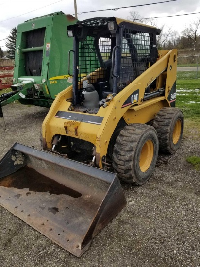 2005 Cat 246B skidloader with material bucket, front remotes, approx. 900 hours, runs good