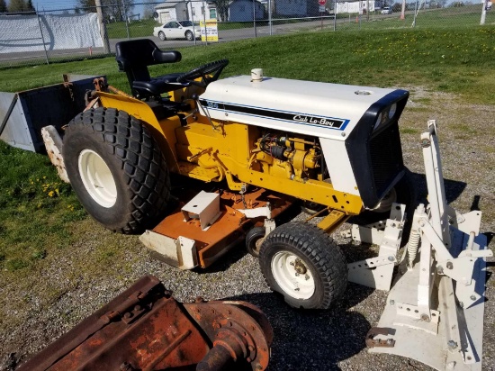 Nice Cub Lo-Boy 154 gas tractor with belly mower, front blade, IH 42 in tiller, and carry all box.