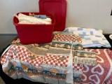 Tote w/ table linens, worn blue quilt, place mats.