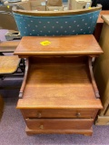 Small side table, missing knob, and green floral upholstered chair