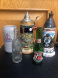 3 beer steins and 2 glass bottles
