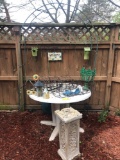 Plastic patio table, wrought iron flower baskets, metal arbor, bird houses, etc.