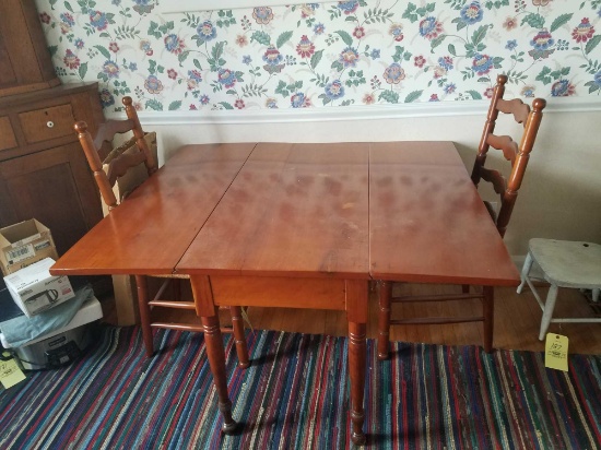 Cherry drop leaf table with 2 ladder back chairs and table pads