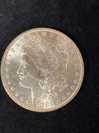 1883-O Morgan dollar, AU.