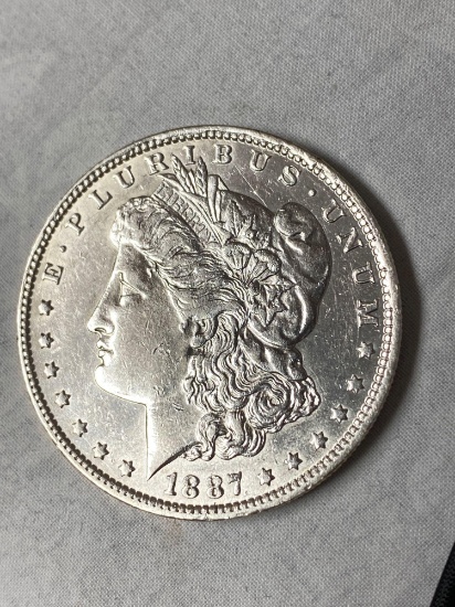 1887-O Morgan dollar, AU.