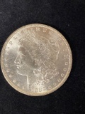 1883-O Morgan dollar, AU.