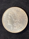 1878 Morgan dollar, (7) tail feathers, AU.