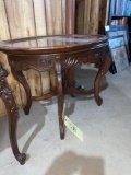 Ornate carved side table with glass serving tray