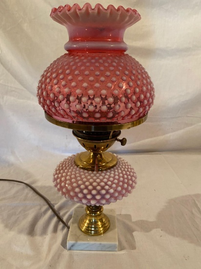 Fenton cranberry opalescent hobnail lamp. Note that metal has split at center of lamp. See second