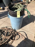 Garden hose and 2 trash cans