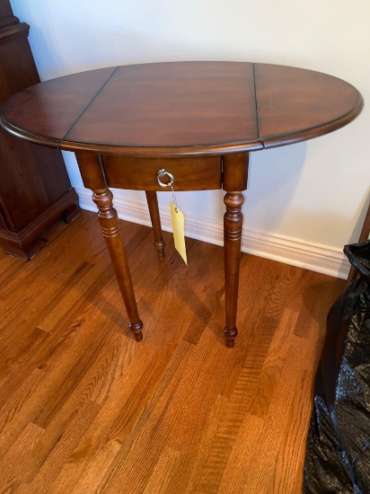 Oval drop-leaf stand, 36" wide.