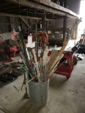 Misc. stakes in a galvanized trash can