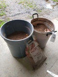 Trash cans with soil, bag of red mulch