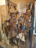 Contents of pegboard, hatchets, hammers, hinges, brackets, pins