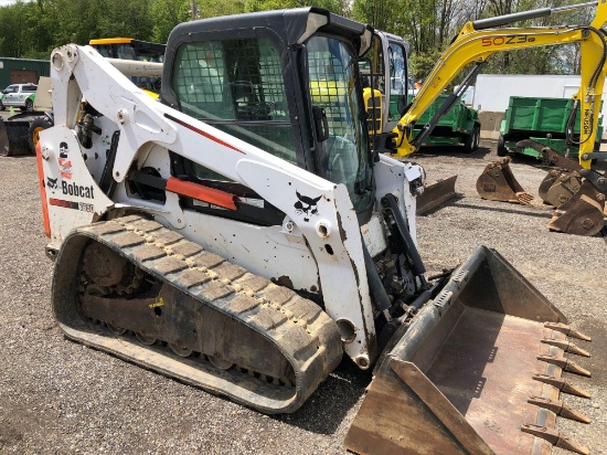 2013 Bobcat T650 with 2 speed, remotes, Bobcat tach quick release, heat & A/C, material bucket