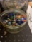 Metal tin full of multicolored marbles