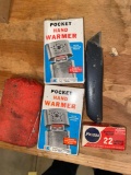 Peters 22 LR cal. ammo, (3) pocket hand warmers, box cutter.