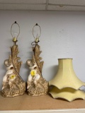 Pair of large chalk ware cherub table lamps with shades