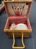 Vintage picnic basket with dishes and utensils