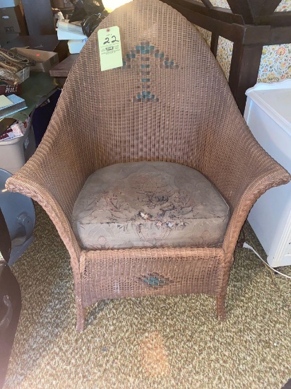 Old wicker chair w/ slip cushion.