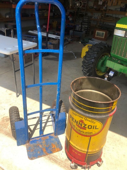 Pneumatic tire heavy duty dolly and Pennzoil trashcan on wheels.