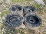 Set of four solid skid loader tire and rims
