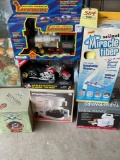 Toy train, motorcycle, baseball water-globe, stand mixer, swivel mop, coffee maker