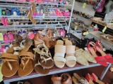 Shelf of assorted shoes and sandals, various sizes