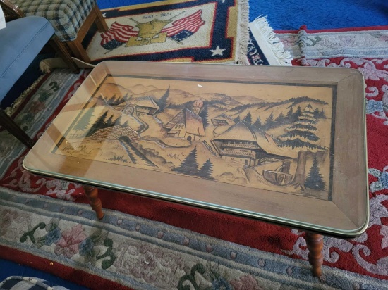 Carved oriental scene coffee table with glass top, 36 x 20 inch top