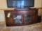 Modern 4-door, 3-drawer TV stand, mahogany finish, 5 ft. x 1 1/2 ft. x 2 1/2 ft. tall