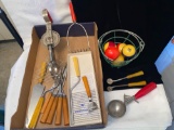 Old kitchen utensils, billiard balls.