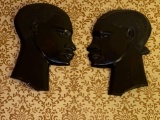 Pair ebony man & woman plaques.